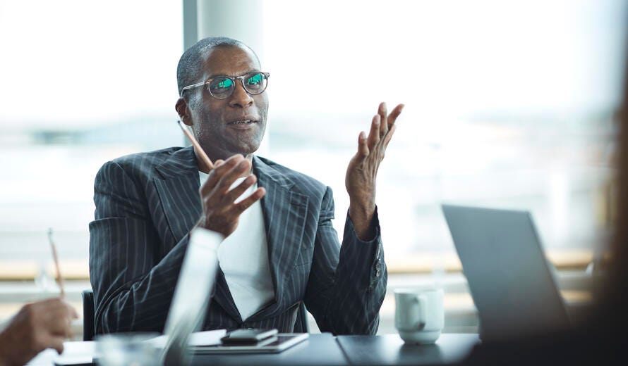 Business people in large modern meeting room