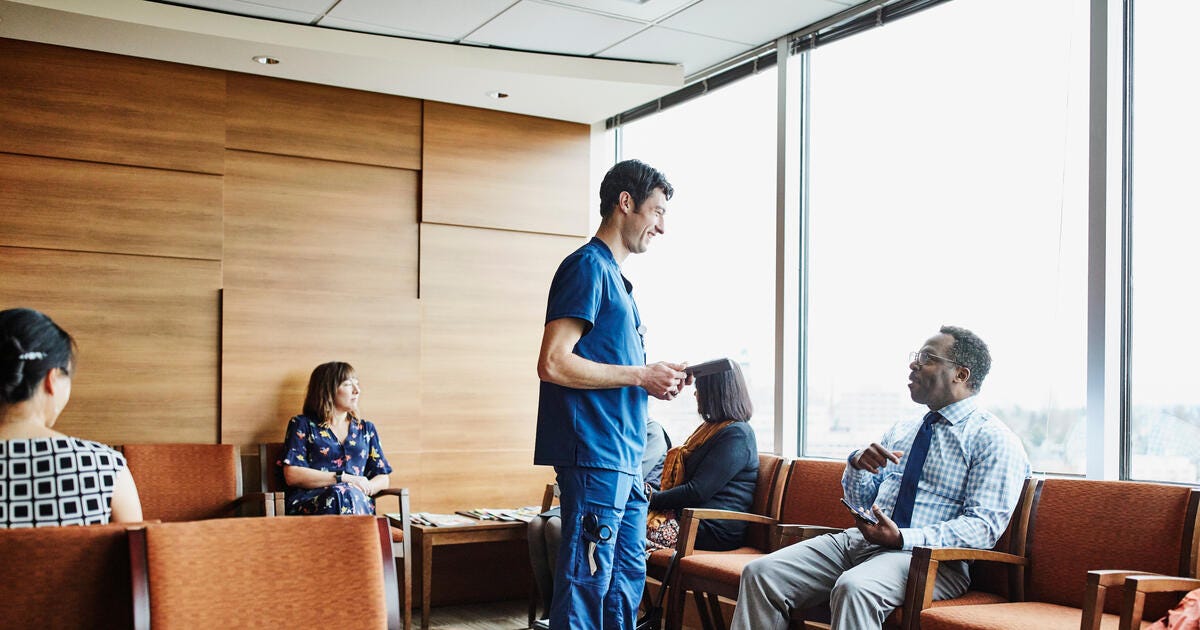 Professional stock image showing individuals seated in a healthcare waiting room.