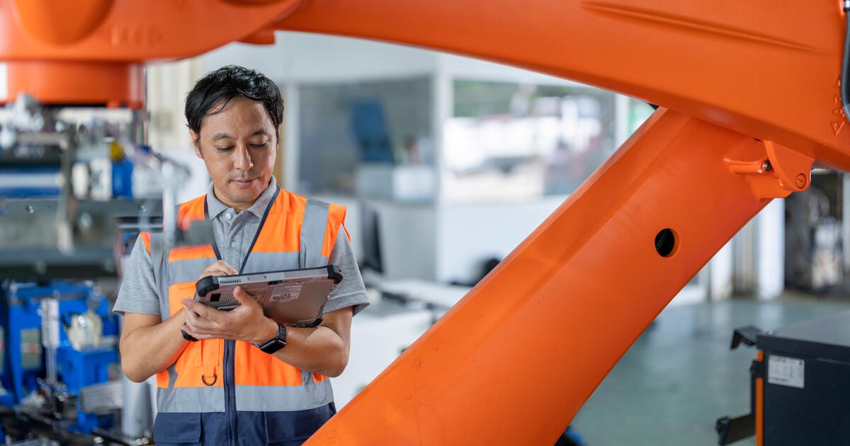 Japanese Engineer inspecting the Robotic Collaborative Conveyor Systems during installation.