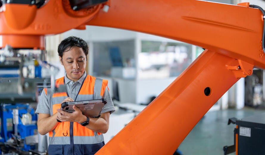 Japanese Engineer inspecting the Robotic Collaborative Conveyor Systems during installation.