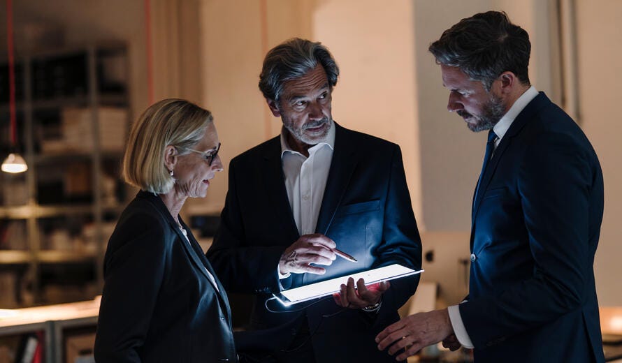 Business people with shining tablet talking in office.
