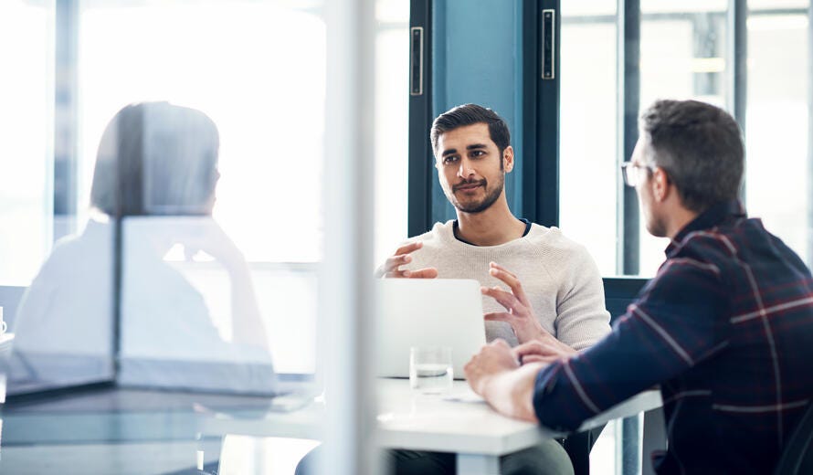 Shot of a group of businesspeople having a discussion in an office