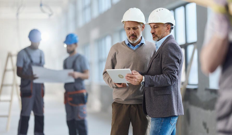 Male building contractors cooperating.